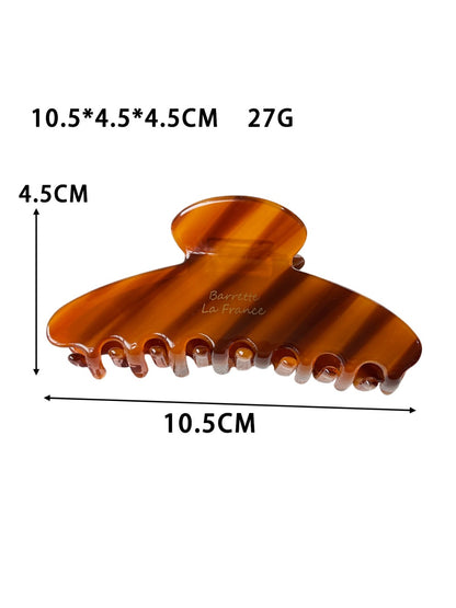 Beau updo claw clip displayed open to show inner teeth and grip structure
