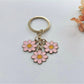 Top view of sweet peach blossom keychain highlighting flower shape and color