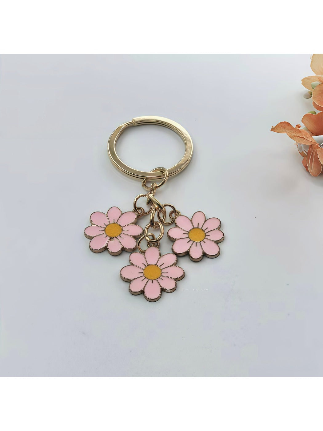 Top view of sweet peach blossom keychain highlighting flower shape and color