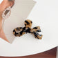 Beau bow hair claw clip styled in an elegant updo on model