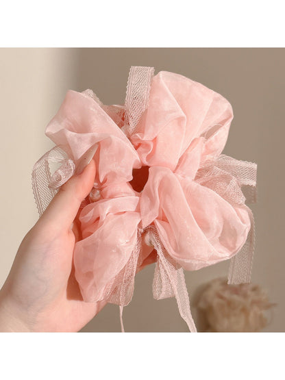 Side view of Gifty bow embellished scrunchie highlighting fabric texture