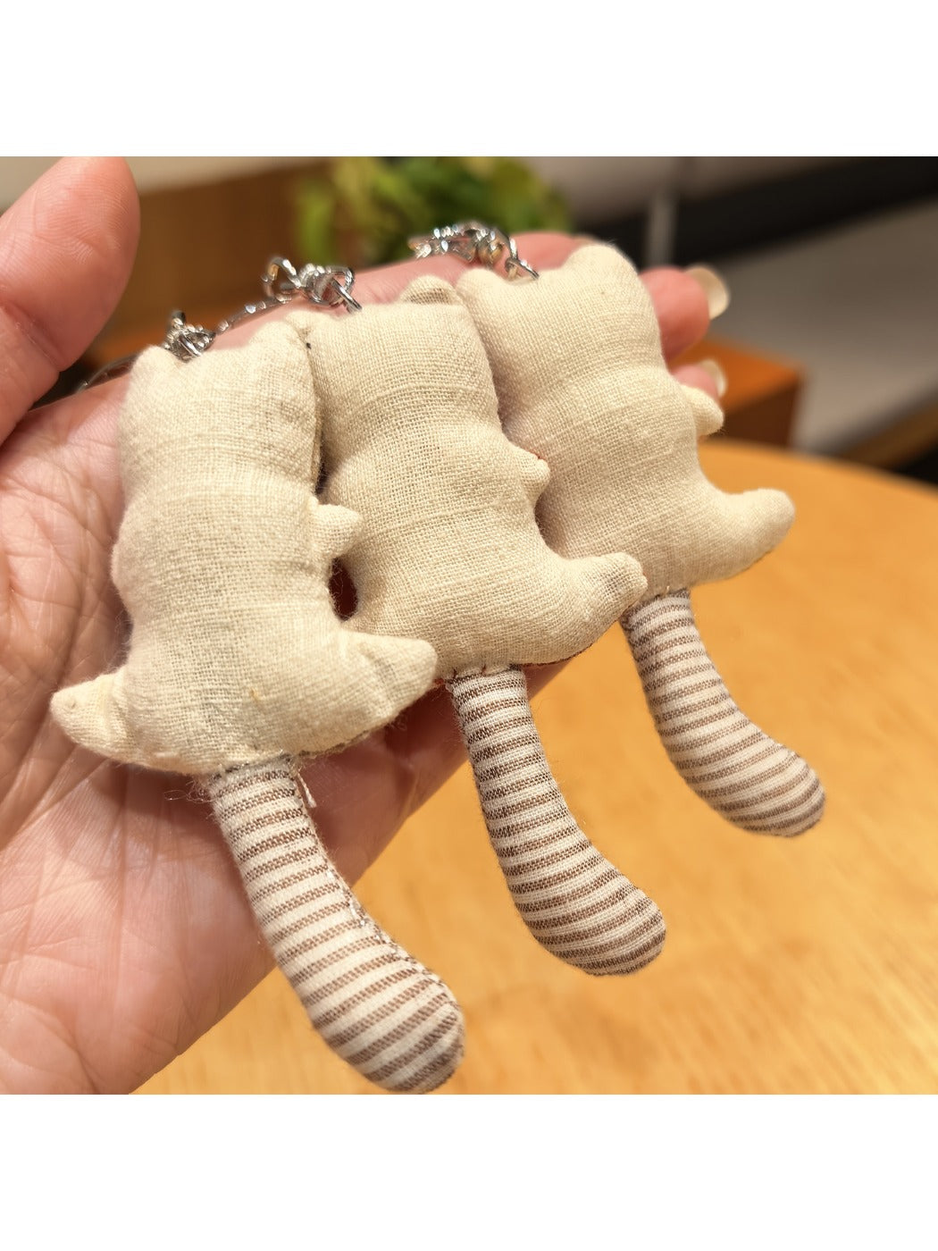 Back view of the bear keychain displaying the full length of its tail