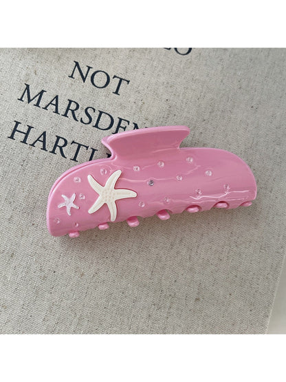Beau starfish half round hair claw clip displayed on a wooden surface
