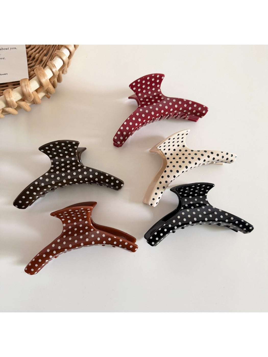 Close-up of Beau polka dot acetate hair clip showing glossy finish and curved shape