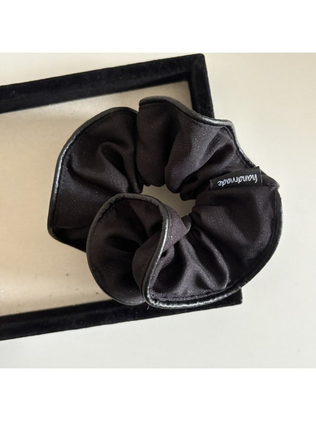 Scrunchie stretched open showing its elastic band inside