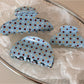 Side view of Beau blue polka dot hair clip with metal clasp