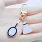 Alloy badminton shuttlecock shaped keychain with metallic finish on white background