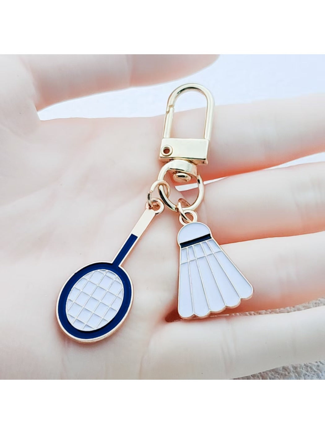 Alloy badminton shuttlecock shaped keychain with metallic finish on white background