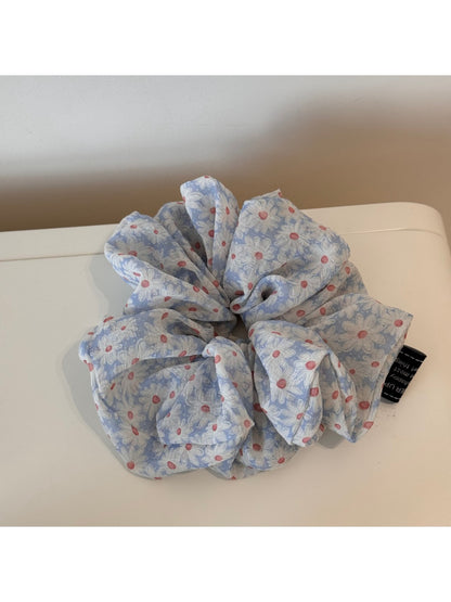 Gifty scrunchie styled in a ponytail with visible white daisy print