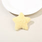 Model wearing two plush star hair clips on both sides of her head with loose hair