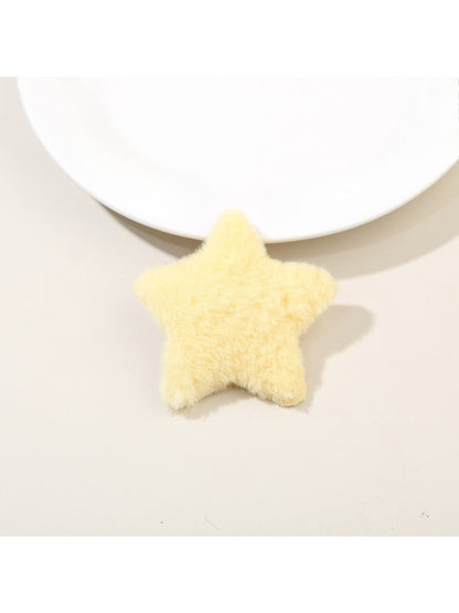 Model wearing two plush star hair clips on both sides of her head with loose hair