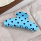 Beau polka dot half circle claw clip showing black and white polka dot pattern