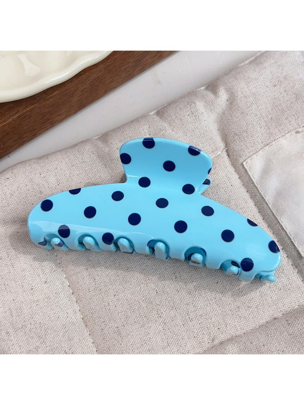 Beau polka dot half circle claw clip showing black and white polka dot pattern