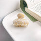 Beau vintage small crescent shaped claw clip in natural light showing color variations