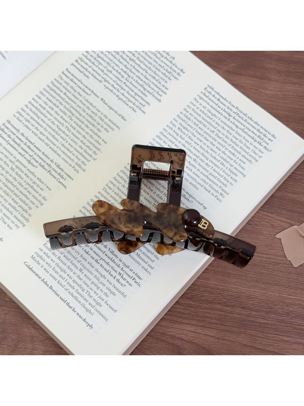 Beau large acetate claw clip holding thick brown hair in an updo style