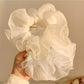 Chic double layer tulle scrunchie in soft pastel pink on white background