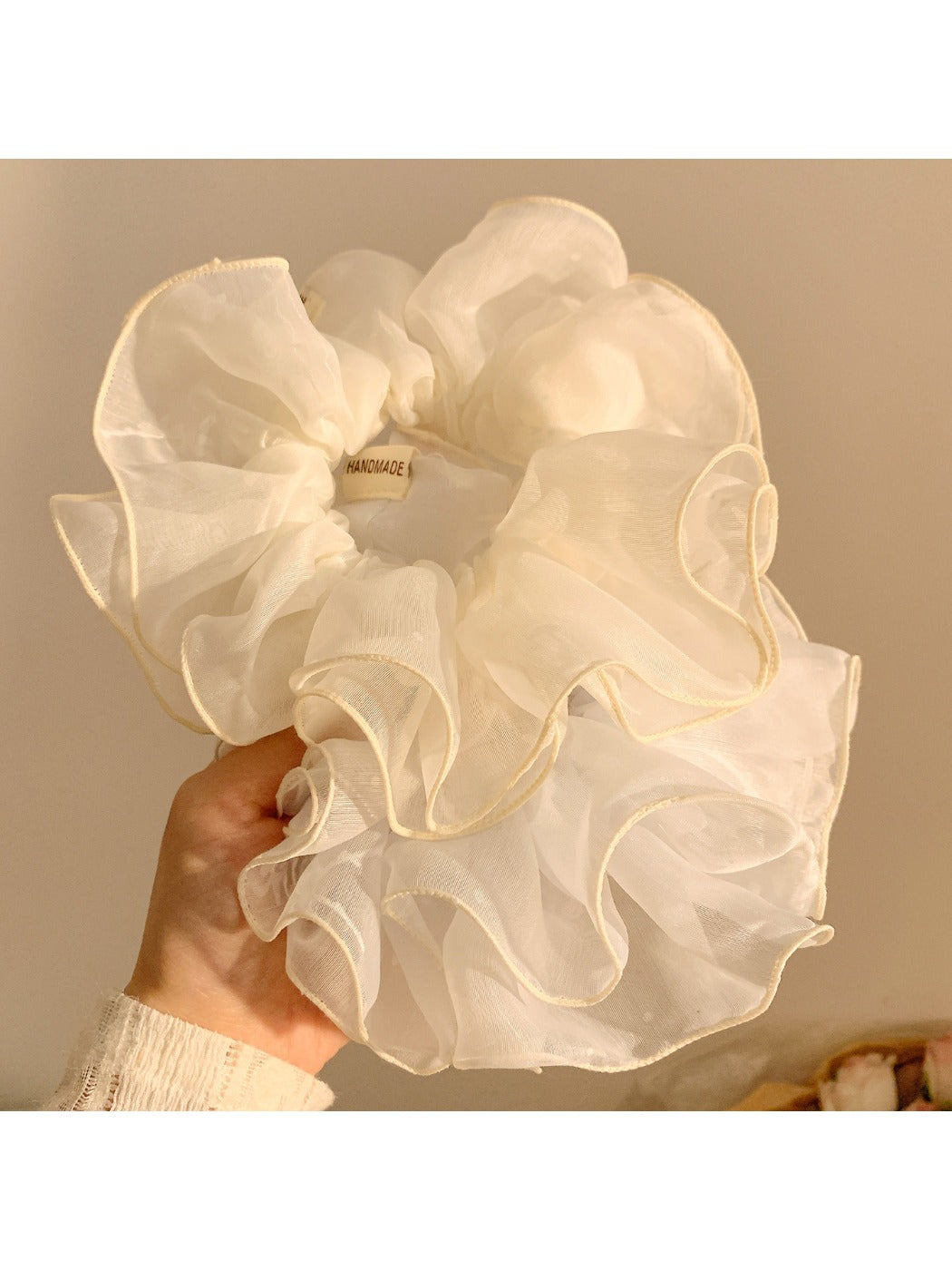 Chic double layer tulle scrunchie in soft pastel pink on white background