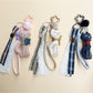 Fabric cat shaped keychain with embroidered details and a metal keyring