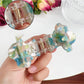 Beau Sweet Rose hair claw clip held in hand displaying size and rose decoration