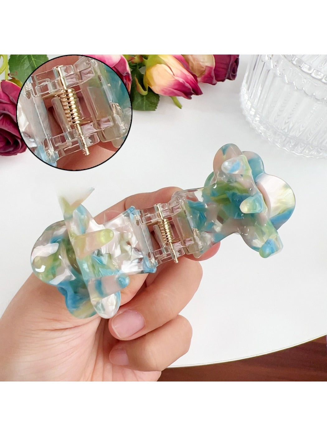 Beau Sweet Rose hair claw clip held in hand displaying size and rose decoration