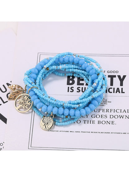 Lovra bracelet styled with casual outfit on model's wrist featuring leaf pendant