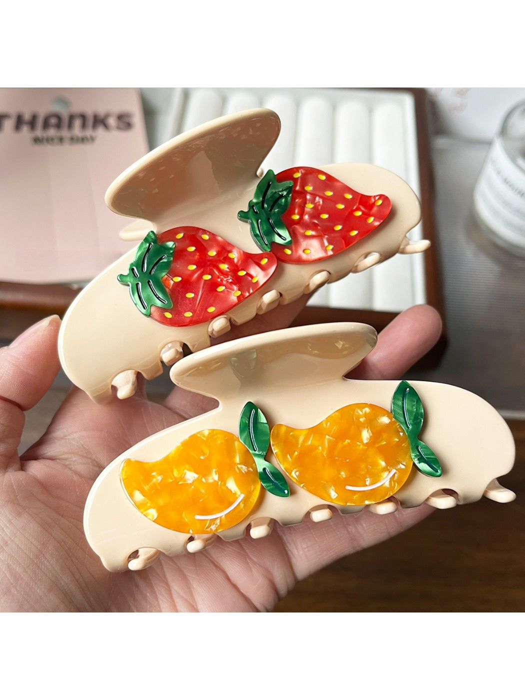 Orange fruit shaped claw clip attached to brown hair