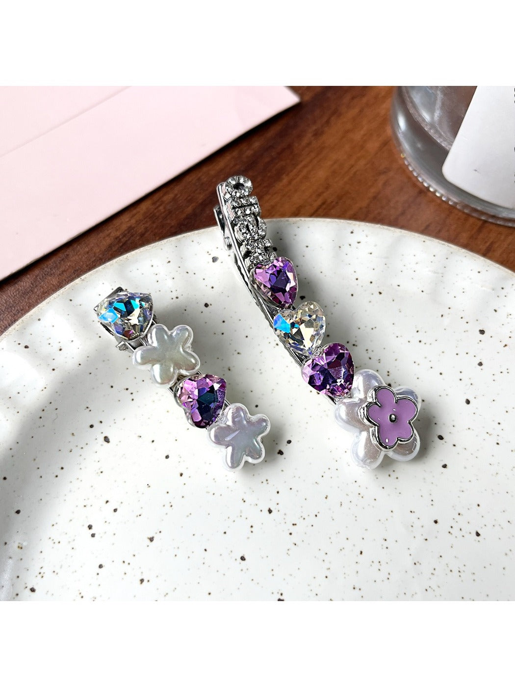 Beau hair clip showing flower design with rhinestones on a white background