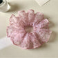 Gifty retro style floral scrunchie styled in a ponytail on a model