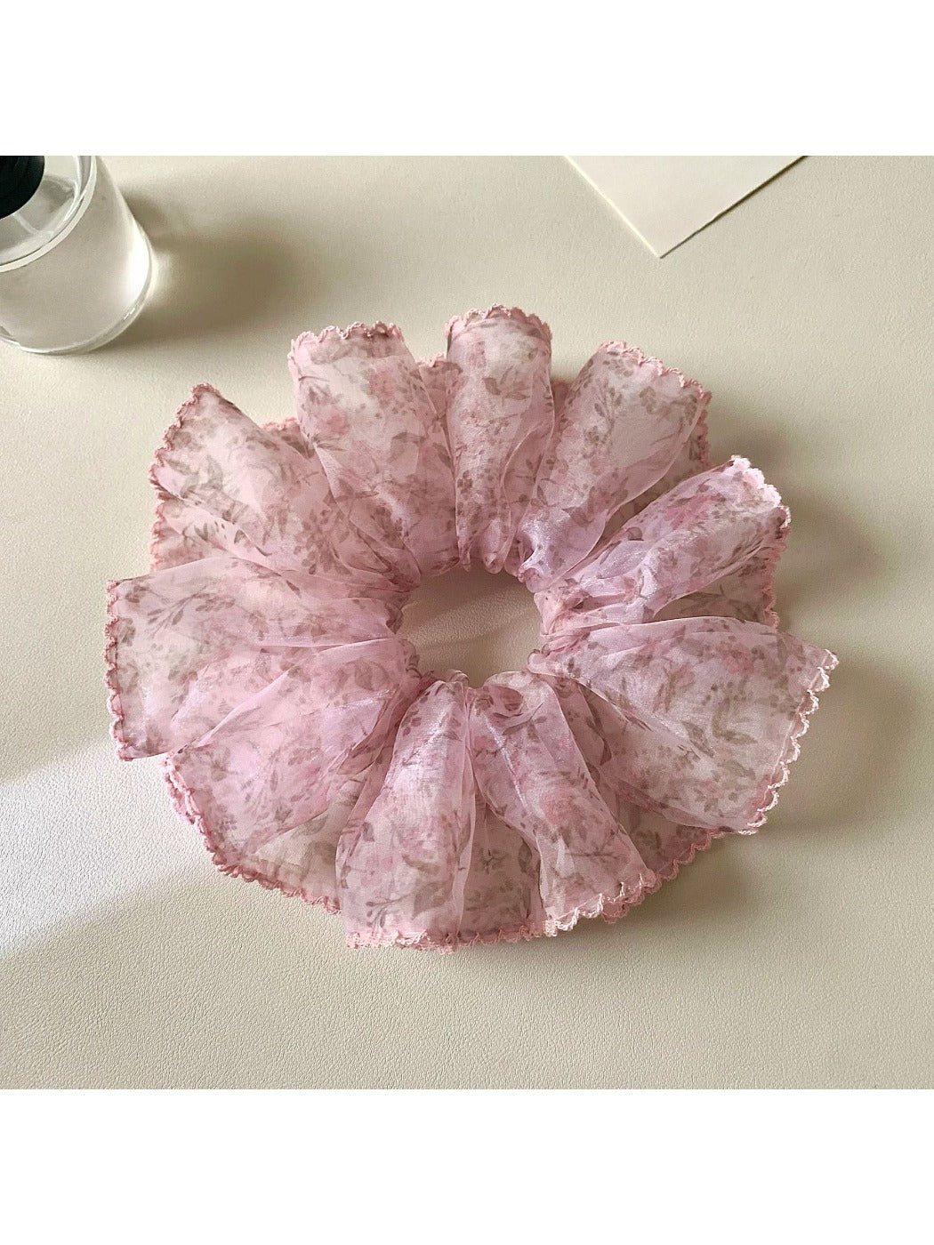 Gifty retro style floral scrunchie styled in a ponytail on a model