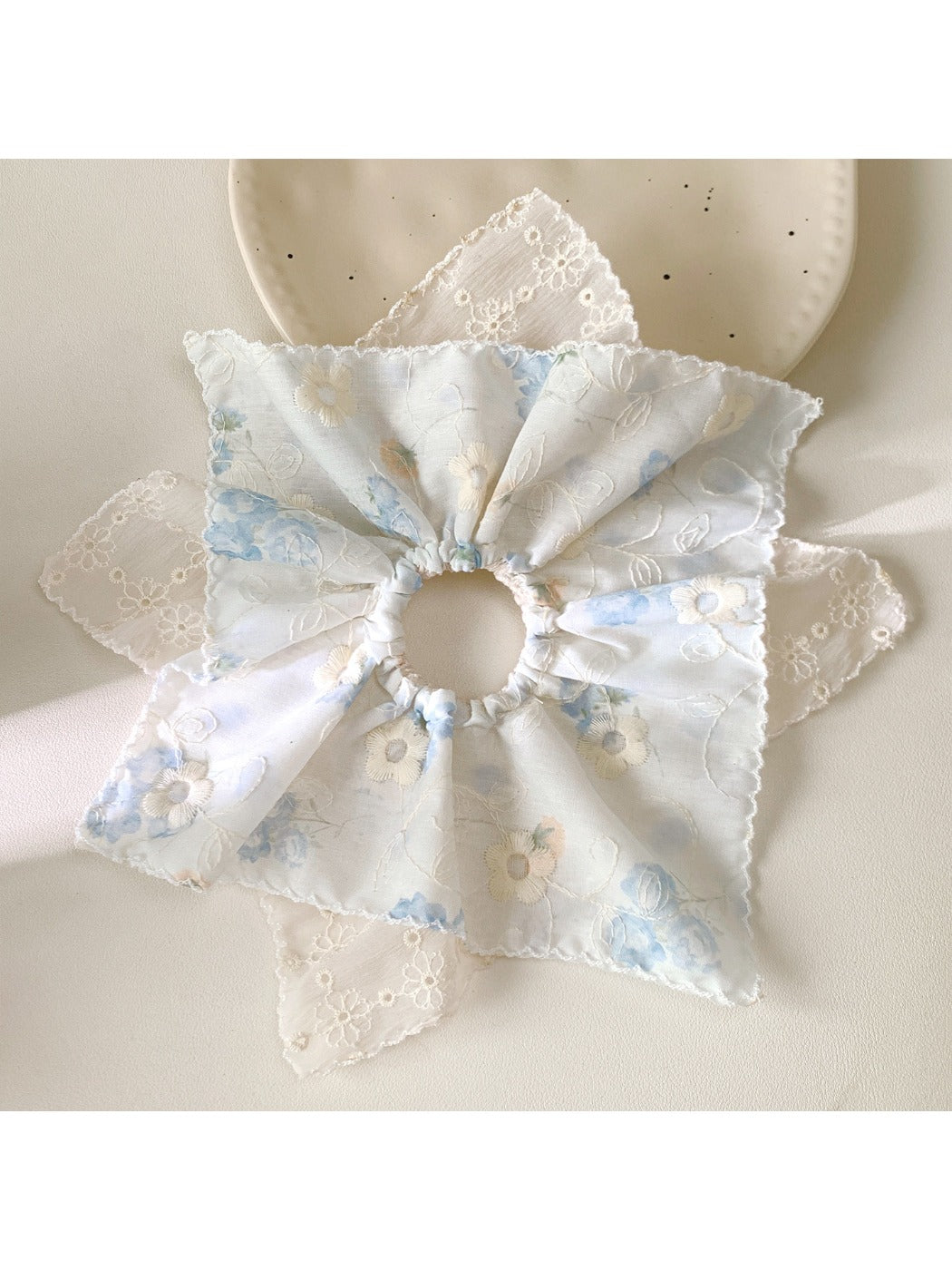Multiple Gifty scrunchies displayed in a flat lay with vibrant patterns and textures