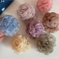 Close-up of Beau rose-shaped hair clip in soft pink color