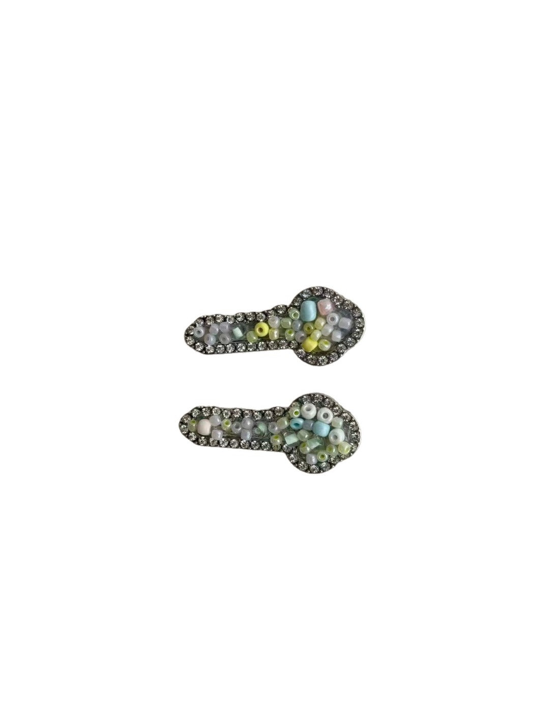 Side view of Beau key shaped hair clip securing hair with a smooth gold surface