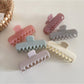 Close-up of Beau rectangular hair clip showing smooth pastel pink surface