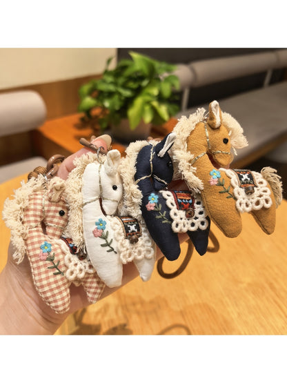 Fabric cute pony bag charm keychain with pink mane and tail on white background