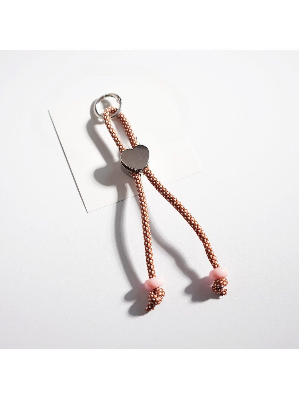Colorful rope heart keychain displayed hanging from a hook