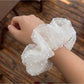Close-up of white polka dot tulle scrunchie showing fabric texture