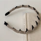 Model wearing beige Gifty solid color corduroy headband with casual outfit