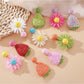 Beau raffia woven hair clip shaped like a strawberry flower on a white background