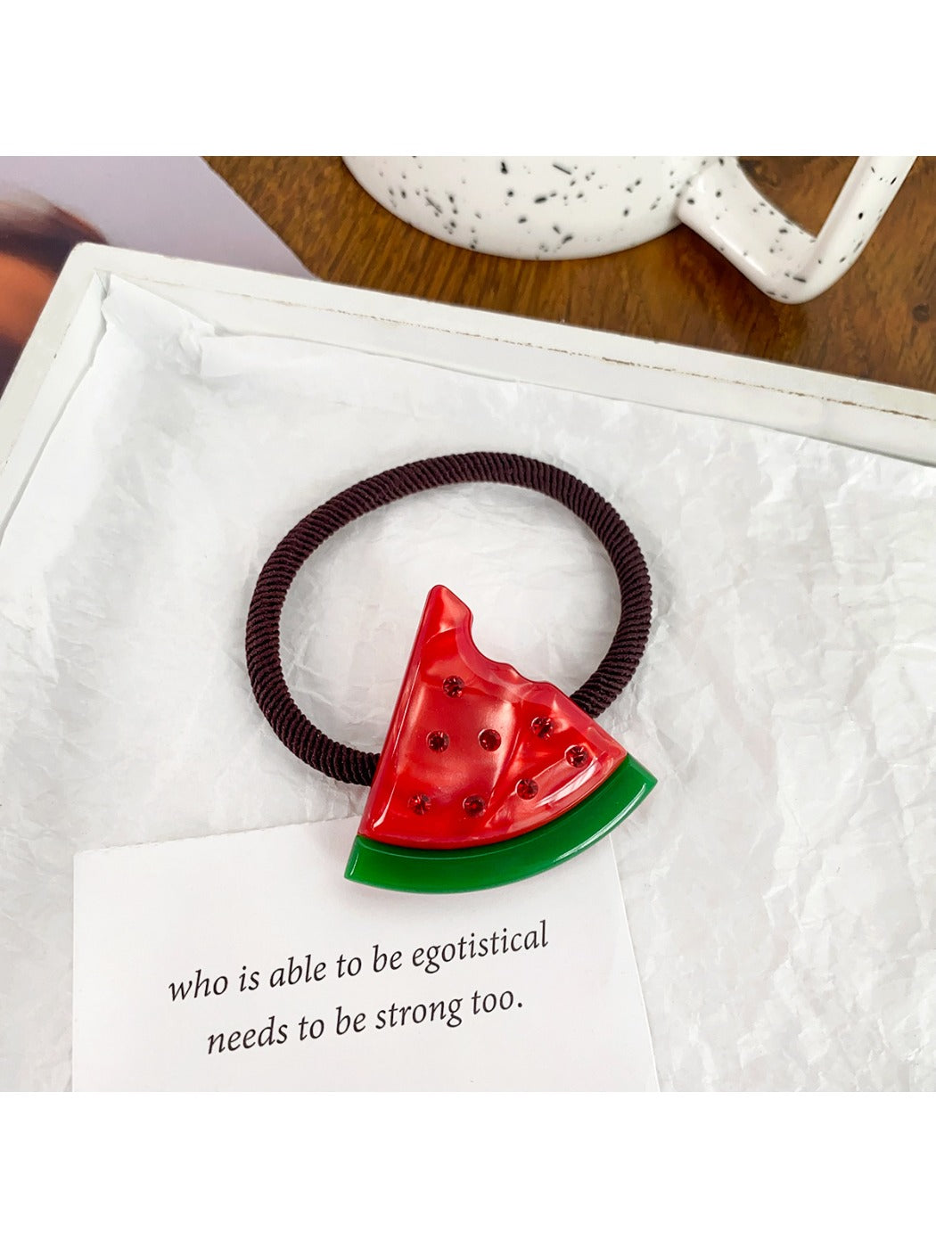Green hair tie featuring a kiwi fruit charm