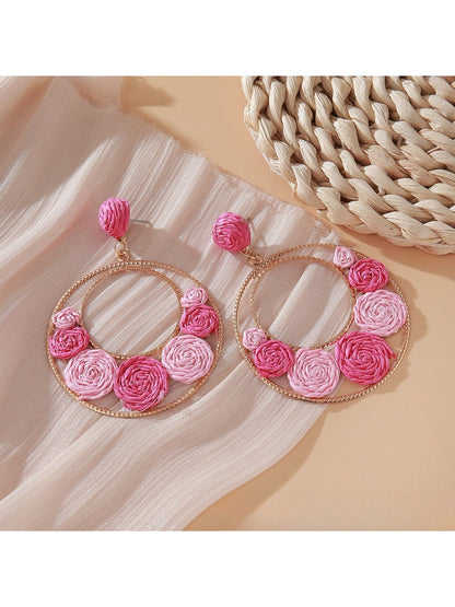Sweet Raffia Circle Stud Earrings photographed with green plant background