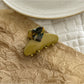 Beau heart shaped acetate claw clip positioned to show heart shape and clasp teeth