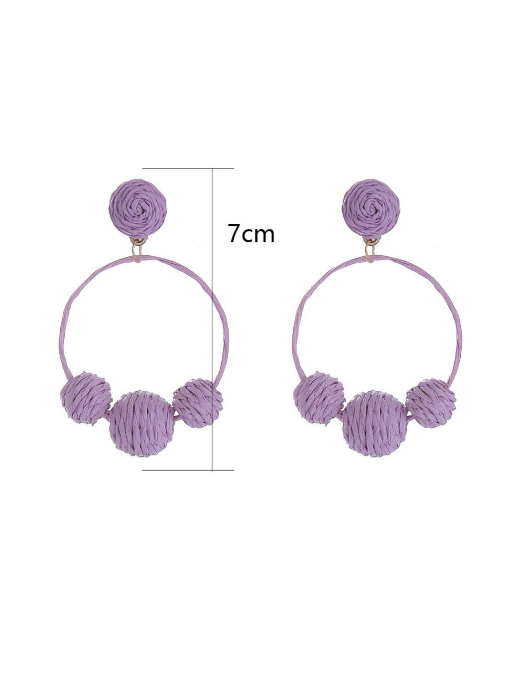 Earedge raffia round ball earrings hanging on a white display stand
