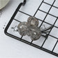 Beau small butterfly claw clip resting on a wooden surface
