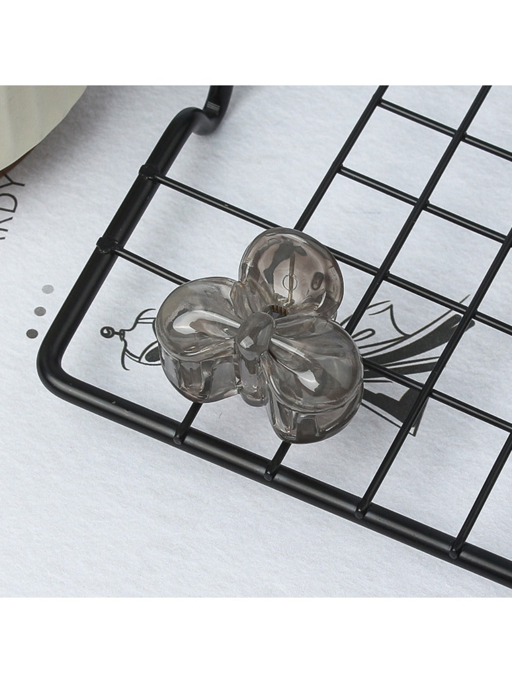 Beau small butterfly claw clip resting on a wooden surface