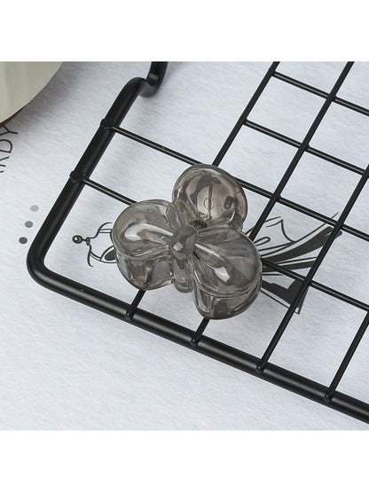 Beau small butterfly claw clip resting on a wooden surface