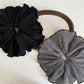 Close-up of Gifty vintage plaid fabric scrunchie in brown and beige tones
