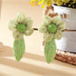 Earrings placed on a wooden surface highlighting texture and craftsmanship