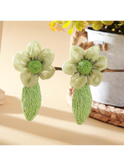 Earrings placed on a wooden surface highlighting texture and craftsmanship