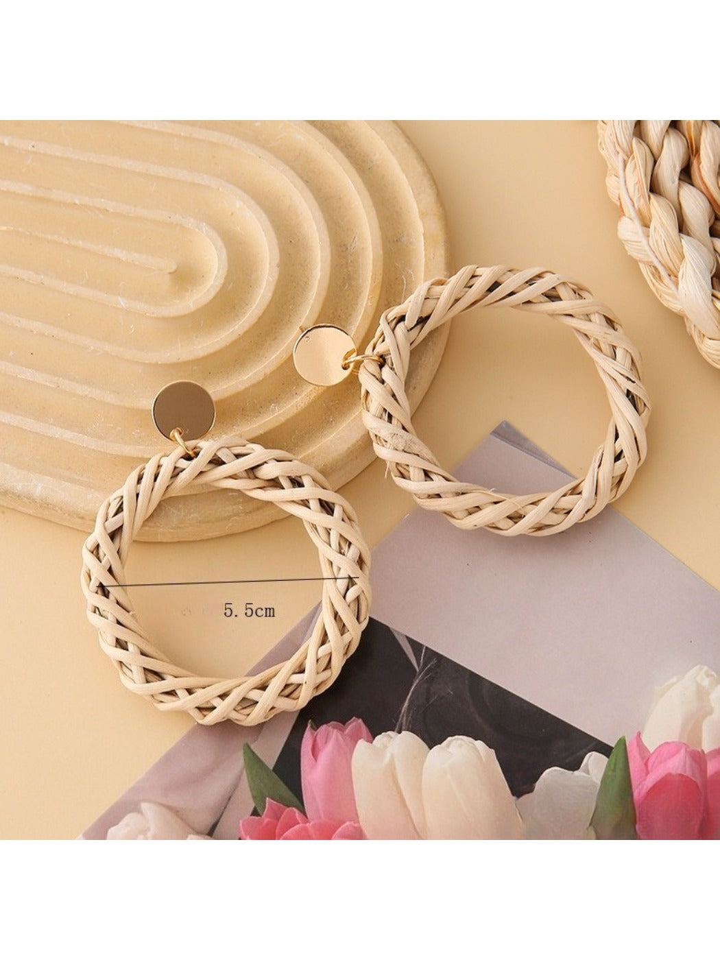 Pair of Earedge rattan round hollow earrings hanging on a jewelry stand