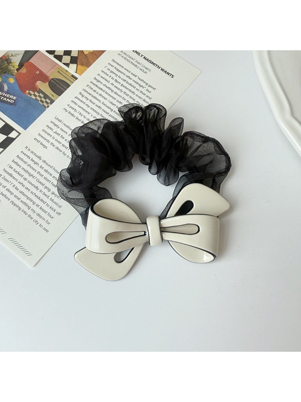 Gifty scrunchie worn on a model's wrist with mesh bow visible